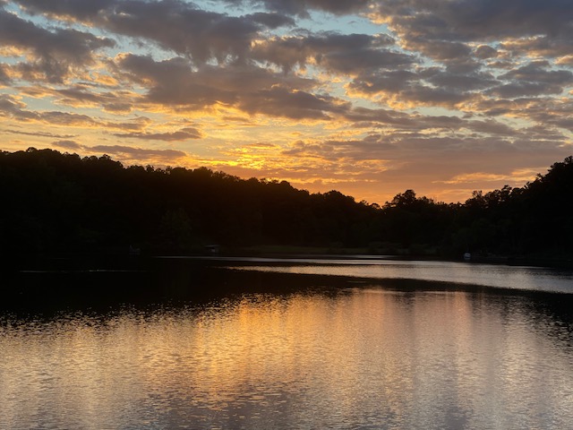 Golden sunset over a lake with cloud reflections